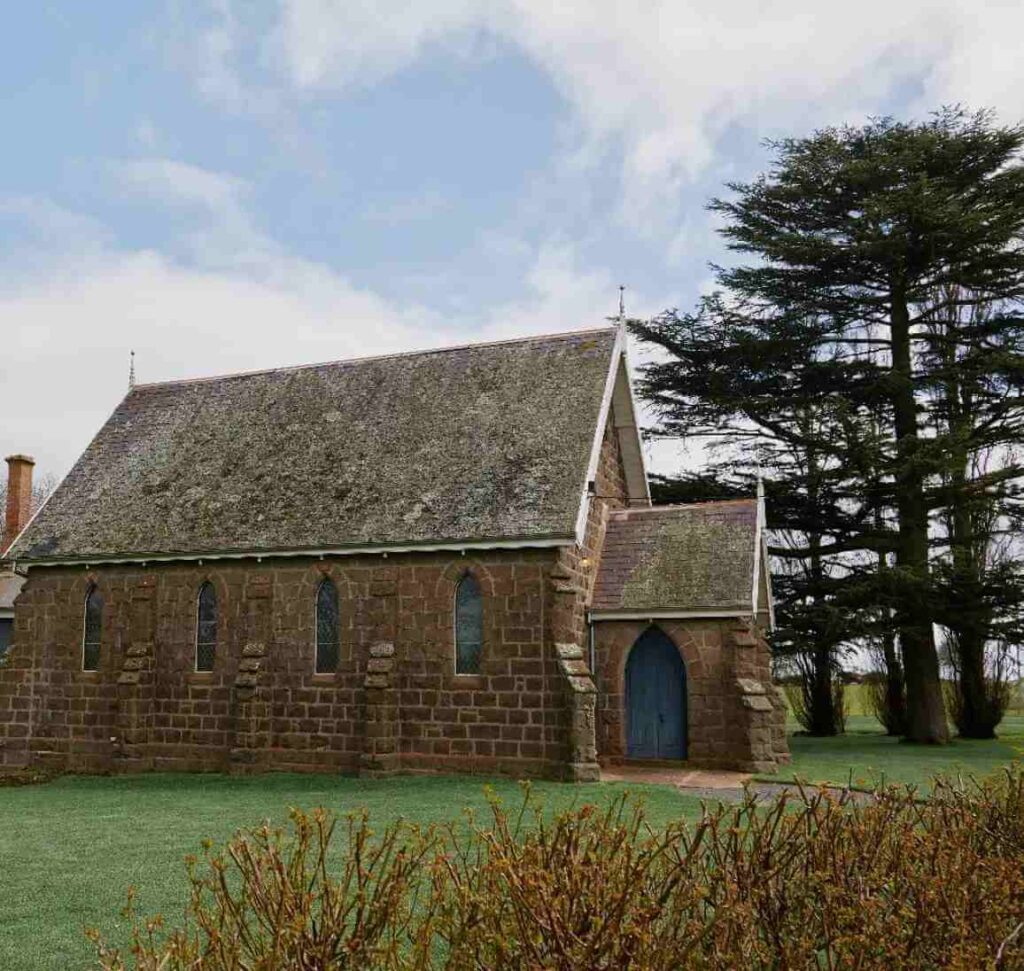 A brick church surrounded by grass