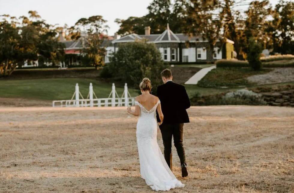 Married couple walking across a field