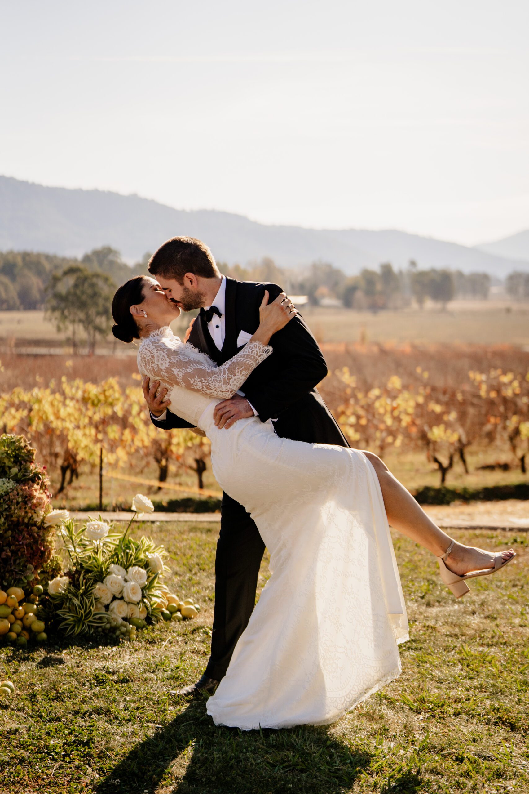 Bride and groom kissing with mountains in the background