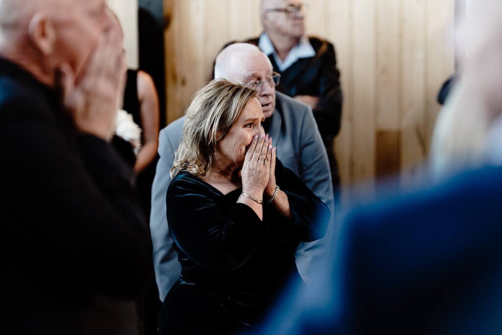 A mother gets teary eyed at her child's wedding ceremony.