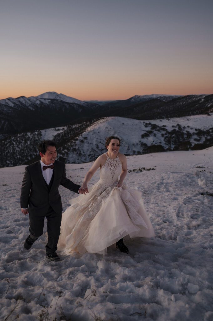 Couple married and walking in snow at Mount Hotham